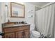 Clean bathroom features a granite vanity, framed mirror, and shower-tub combination at 12455 W Alameda Dr, Lakewood, CO 80228