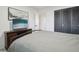 Comfortable bedroom with dark closet doors and plenty of space for entertainment at 12455 W Alameda Dr, Lakewood, CO 80228