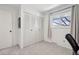 Neutral bedroom featuring a closet with sliding doors and a window at 12455 W Alameda Dr, Lakewood, CO 80228