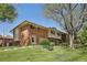 Charming townhome with red brick, neutral siding, and well-maintained front lawn and landscaping at 12455 W Alameda Dr, Lakewood, CO 80228