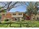 Charming townhome with red brick, neutral siding, and well-maintained front lawn and bushes at 12455 W Alameda Dr, Lakewood, CO 80228
