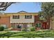 Charming townhome with red brick and well-maintained front lawn and landscaped bushes at 12455 W Alameda Dr, Lakewood, CO 80228