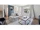 Modern living room with neutral sofa, stylish coffee table, and large window with great natural light at 12455 W Alameda Dr, Lakewood, CO 80228