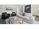Modern living room with neutral sofa, black armchairs, and contemporary decor at 12455 W Alameda Dr, Lakewood, CO 80228