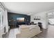 Modern living room with neutral sofa, TV on dark accent wall, and stylish decor at 12455 W Alameda Dr, Lakewood, CO 80228