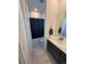 Modern bathroom with sleek vanity, large mirror, and shower with dark curtain at 15682 W Girard Ave, Morrison, CO 80465