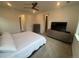 Main bedroom with large TV and ensuite bathroom access at 15682 W Girard Ave, Morrison, CO 80465