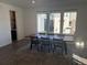 Modern dining area with wooden table and access to wet bar at 15682 W Girard Ave, Morrison, CO 80465