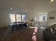 Bright dining area with large windows and a long wooden table at 15682 W Girard Ave, Morrison, CO 80465