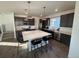 Modern kitchen with large island and stainless steel appliances at 15682 W Girard Ave, Morrison, CO 80465