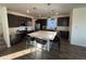 Modern kitchen with large island and stainless steel appliances at 15682 W Girard Ave, Morrison, CO 80465