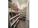Well-stocked pantry with ample shelving for storage at 15682 W Girard Ave, Morrison, CO 80465