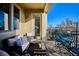 Private balcony with comfortable seating and a bistro table, perfect for outdoor relaxation at 5592 S Nevada St # 306, Littleton, CO 80120