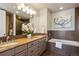 Elegant bathroom with double vanities, a soaking tub, and a separate shower at 5592 S Nevada St # 306, Littleton, CO 80120