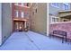 Side entrance to building with brick accents and bench at 5592 S Nevada St # 306, Littleton, CO 80120