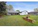 Expansive backyard with mature trees and lush green grass at 6267 Fenton St, Arvada, CO 80003