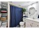 Cozy bathroom featuring fresh towels, a shower with curtain, and functional storage shelves at 6267 Fenton St, Arvada, CO 80003