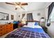 Bright bedroom featuring a plaid cover, ceiling fan and warm lighting creating a peaceful space at 6267 Fenton St, Arvada, CO 80003