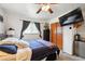 This cozy bedroom features a ceiling fan, a mounted TV, and a comfortable bed with blue covers at 6267 Fenton St, Arvada, CO 80003