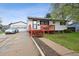 Exterior view featuring a well-maintained home with a red front porch and a detached two-car garage at 6267 Fenton St, Arvada, CO 80003