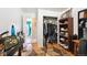 Hallway with wooden floors, an open closet, and desk with a picture frame at 6267 Fenton St, Arvada, CO 80003