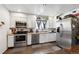 Bright kitchen featuring white cabinets, stainless steel appliances, and ample counter space for meal preparation at 6267 Fenton St, Arvada, CO 80003