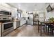 Functional kitchen with white cabinetry, stainless steel appliances, and a dining area for casual meals at 6267 Fenton St, Arvada, CO 80003