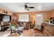 Spacious living room featuring ample seating, a ceiling fan, and large windows for natural light at 6267 Fenton St, Arvada, CO 80003