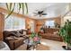 Comfortable living room with plush sofas, a ceiling fan, and natural light, creating a welcoming atmosphere at 6267 Fenton St, Arvada, CO 80003
