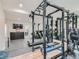 Home gym with a full set of weights, a treadmill, and a mirror at 2635 Spruce Meadows Dr, Broomfield, CO 80023