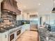 Spacious kitchen with copper farm sink and stainless steel appliances at 2635 Spruce Meadows Dr, Broomfield, CO 80023