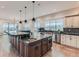 Island kitchen with granite countertops and modern lighting at 2635 Spruce Meadows Dr, Broomfield, CO 80023