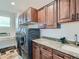 Bright laundry room with modern washer and dryer and ample storage at 2635 Spruce Meadows Dr, Broomfield, CO 80023