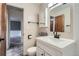 Bright bathroom with white vanity, modern black hardware, decorative mirror, and neutral paint at 1201 Moline St, Aurora, CO 80010