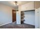 Bedroom featuring neutral paint, carpeted floors, a light fixture, and closet with shelving at 1201 Moline St, Aurora, CO 80010