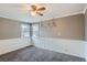 Bedroom features neutral paint, carpeted floors, wainscoting, a ceiling fan, and abundant natural light at 1201 Moline St, Aurora, CO 80010