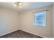 Cozy bedroom featuring neutral paint, carpeted floors, a light fixture, and window with privacy at 1201 Moline St, Aurora, CO 80010