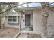 Close up of the home's entry featuring a secure door and a small bench at 1201 Moline St, Aurora, CO 80010