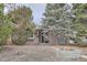 Cozy single-story home featuring mature trees and a walkway leading to the entrance at 1201 Moline St, Aurora, CO 80010