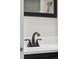 Bathroom vanity with a white sink, and oil rubbed bronze faucet and hardware at 8737 Santa Fe Dr, Thornton, CO 80260