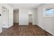Bright bedroom with wood floors and access to other rooms at 8737 Santa Fe Dr, Thornton, CO 80260
