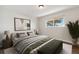 Bright bedroom with a large window, modern decor, and cozy furnishings at 8737 Santa Fe Dr, Thornton, CO 80260