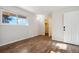 Sunlit bedroom with wood floors, bright windows, with doors leading to other rooms at 8737 Santa Fe Dr, Thornton, CO 80260