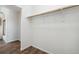 A spacious closet with hardwood floors, wooden shelving, and white walls at 8737 Santa Fe Dr, Thornton, CO 80260