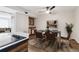 The dining room features a glass table and a ceiling fan at 8737 Santa Fe Dr, Thornton, CO 80260
