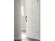 Intricate patterned white door with vintage hardware opens to reveal sunlit room at 8737 Santa Fe Dr, Thornton, CO 80260