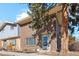 Brick two-story home with a tree in the front yard at 8737 Santa Fe Dr, Thornton, CO 80260