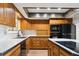 This Kitchen shows oak cabinets, white countertops and black oven and microwave at 8737 Santa Fe Dr, Thornton, CO 80260
