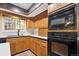 This Kitchen shows oak cabinets, white countertops and black oven and microwave at 8737 Santa Fe Dr, Thornton, CO 80260