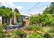 Beautiful backyard features a cozy outdoor seating area surrounded by lush greenery and a brick patio at 178 W Cedar Ave, Denver, CO 80223